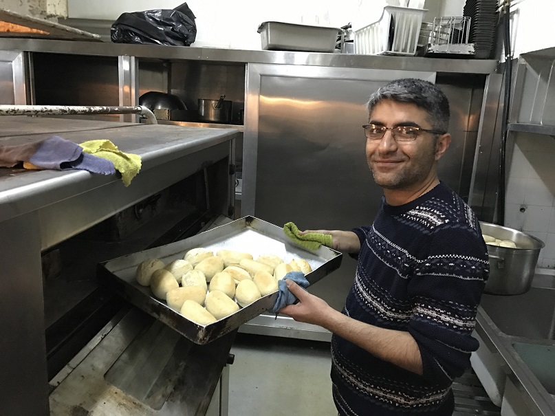 Rostom cooks for other refugees with us 